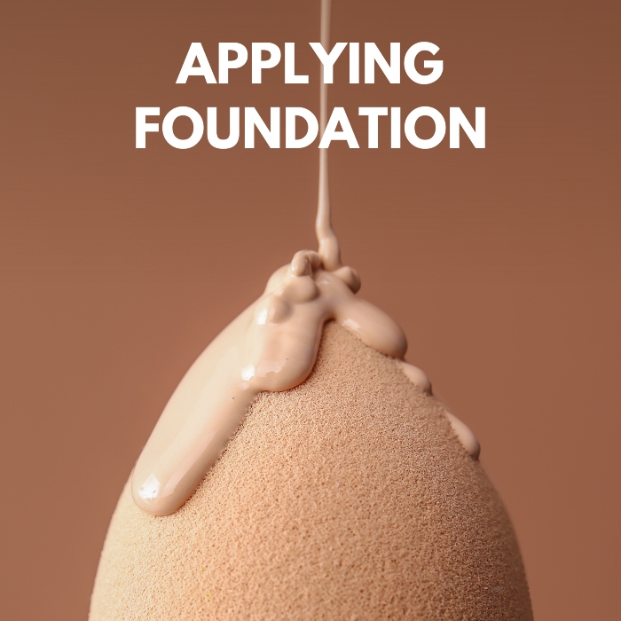 Applying foundation on makeup sponge