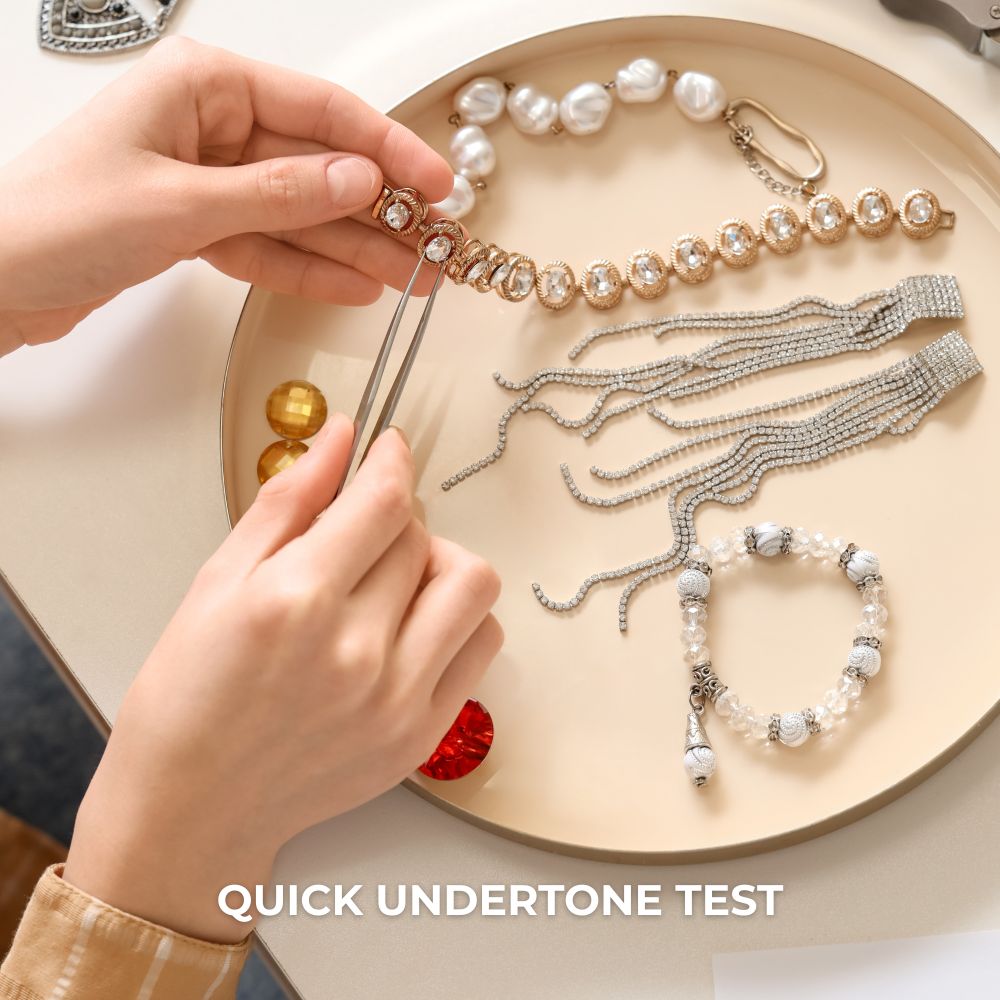 Hands adding beads to a necklace.