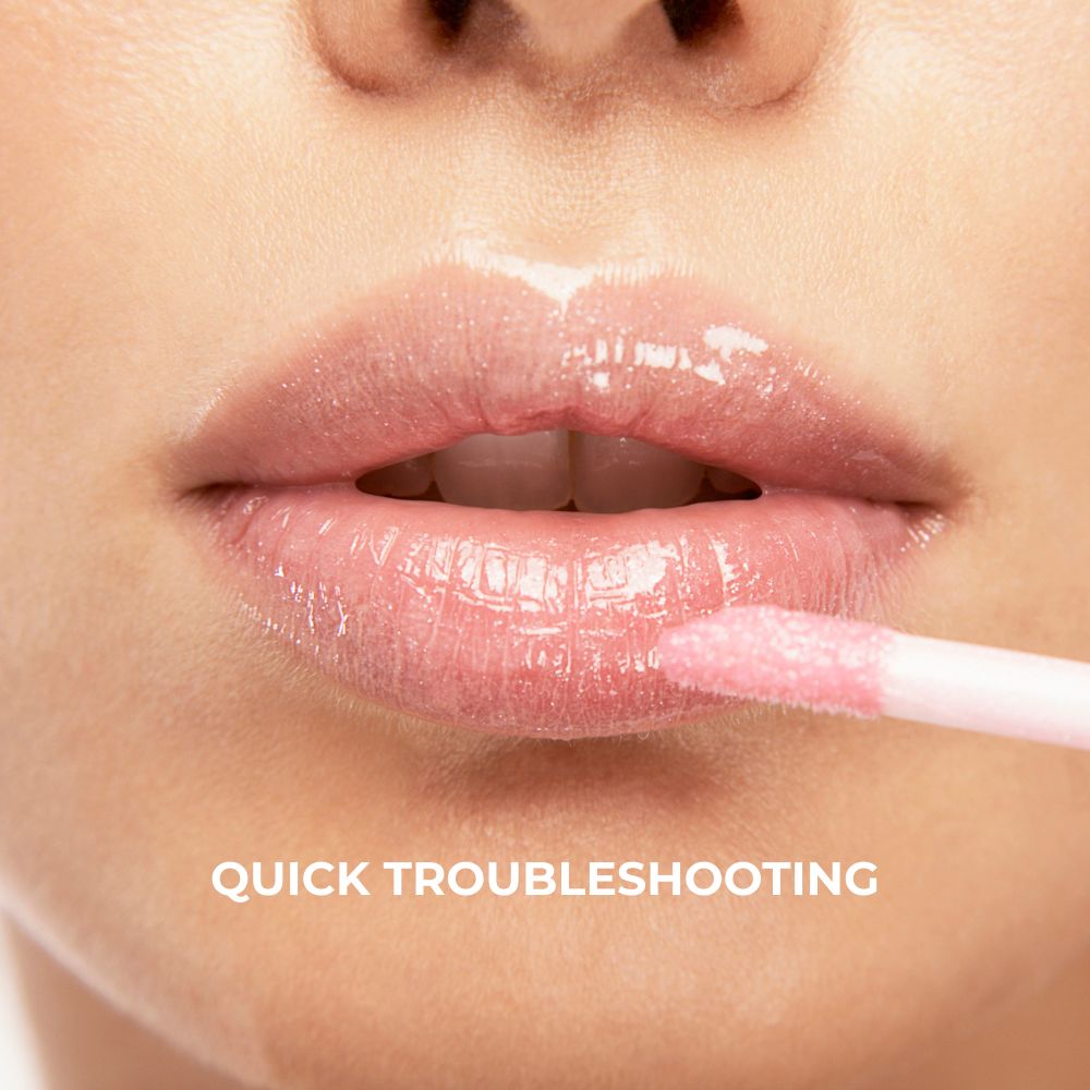 Pink lip gloss being applied close up