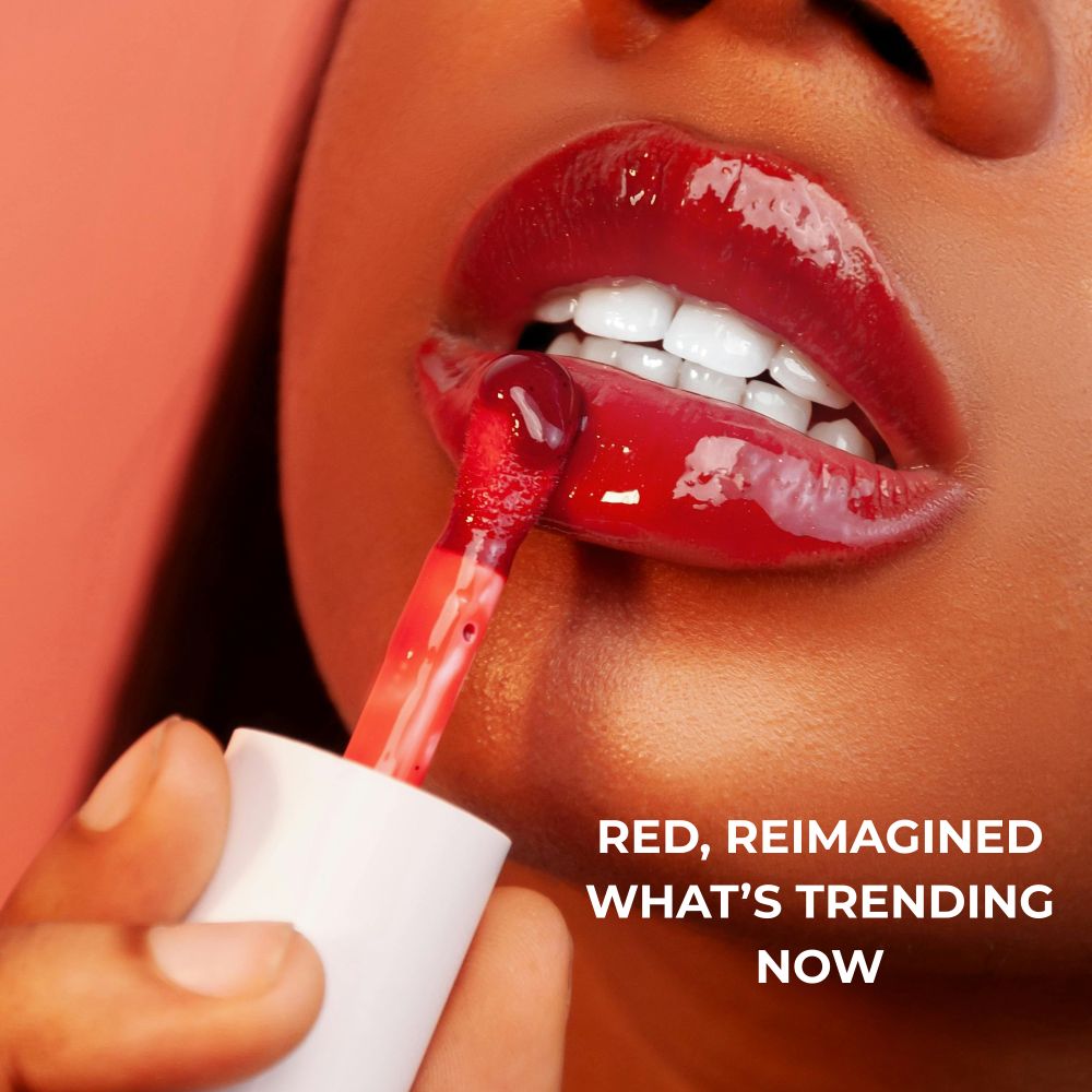 Red lipstick being applied. Red background