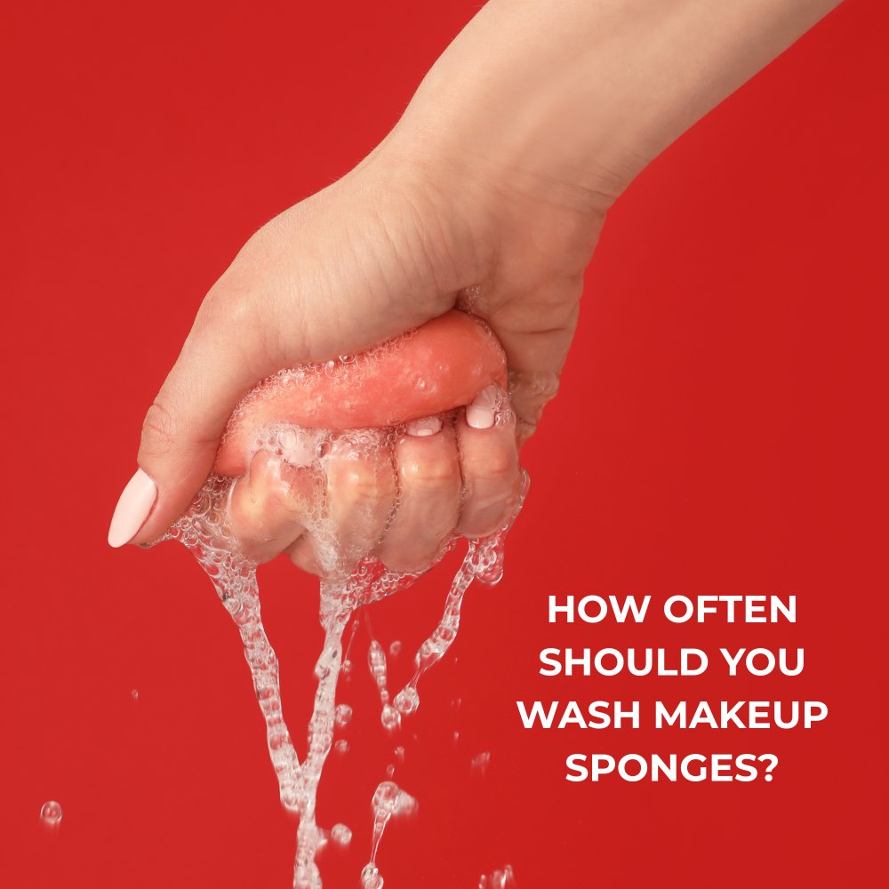 Hand squeezing makeup sponge red background