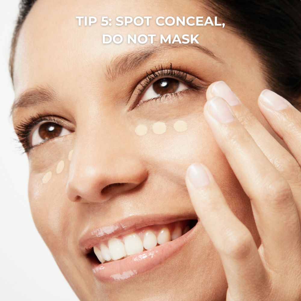 Lady applying concealer